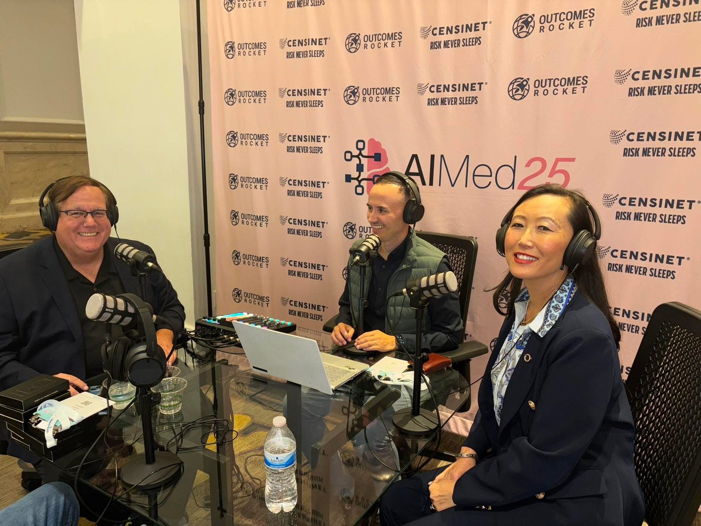 Sherri Douville recording the Outcomes Rocket with Risk Never Sleeps podcast at AIMed 2025 with hosts Ed Gaudet and Saul Marquez